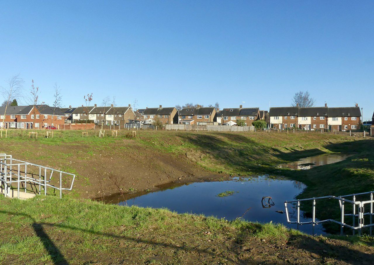 An attenuation pond beside new housing